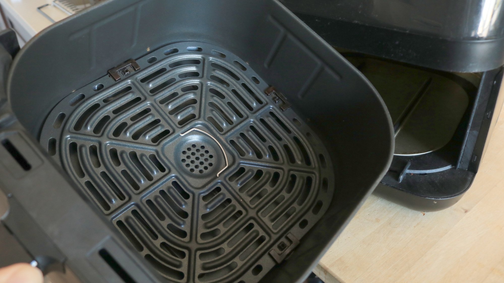 The inside of an air fryer basket.